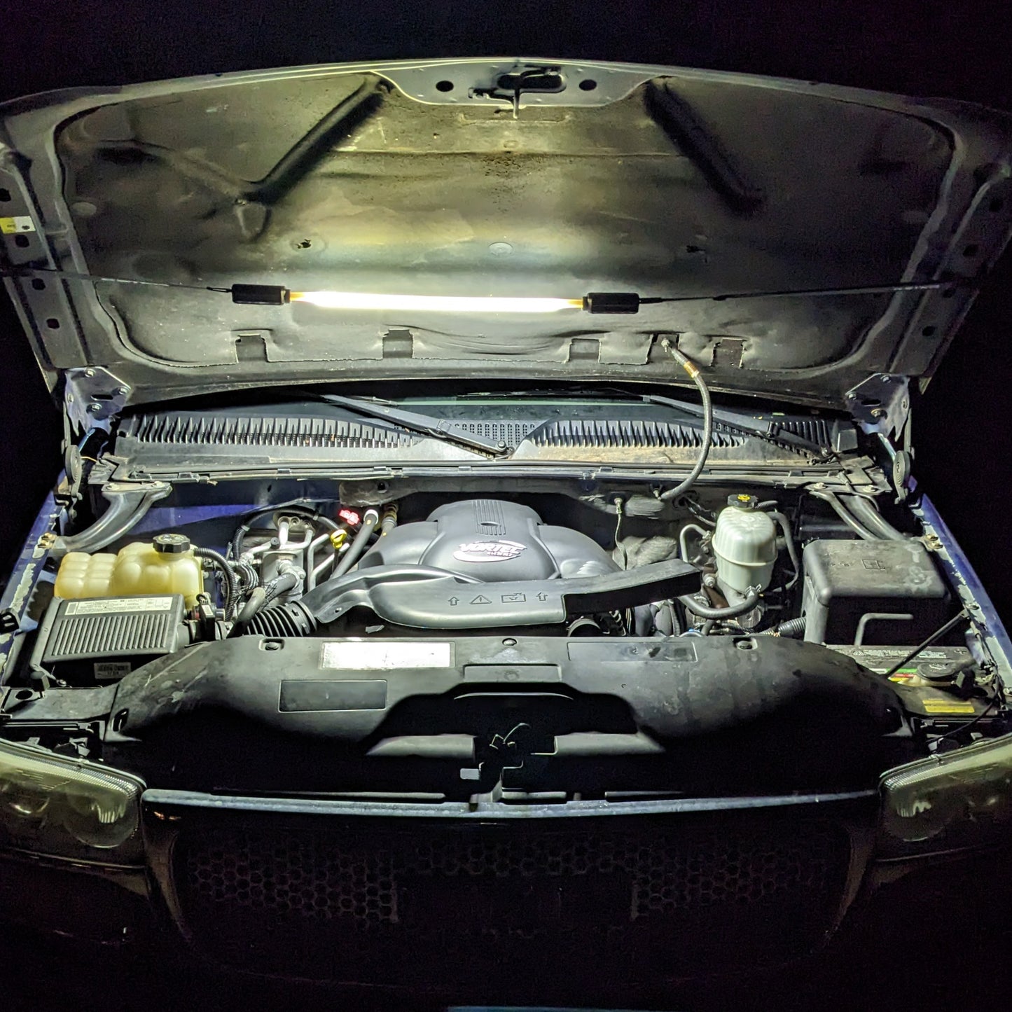 FLEXIT Under Hood Mechanics Light lifestyle shot showing it being used under the hood of a vehicle for potential mechanical work